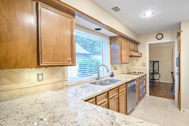 22419 Kent Falls Dr, Katy, TX 77450 - kitchen featuring stainless steel dishwasher, light stone countertops, backsplash, and brown cabinetry