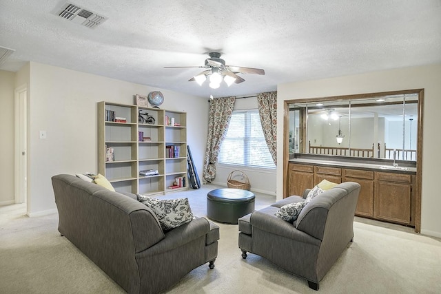 22419 Kent Falls Dr, Katy, TX 77450 - living room with light carpet, a ceiling fan, and a textured ceiling