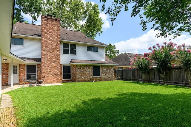 22419 Kent Falls Dr, Katy, TX 77450 - rear view of property with roof with shingles, a fenced backyard, a patio area, and a chimney
