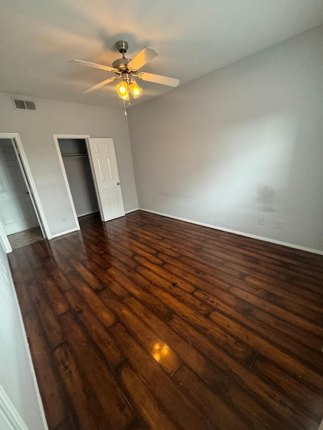6289 Wilcrest Dr Unit 7101, Houston, TX 77072 - unfurnished bedroom featuring dark wood-style flooring, ceiling fan, and a closet