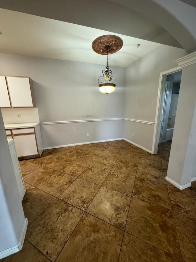 6289 Wilcrest Dr Unit 7101, Houston, TX 77072 - unfurnished dining area featuring arched walkways and dark tile patterned flooring
