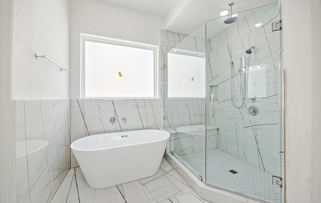 10927 Brookeshire Chase Ln, Houston, TX 77043 - bathroom with a stall shower, a soaking tub, marble finish flooring, and tile walls