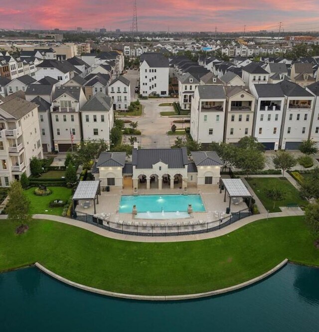 3507 Eaton Estates Ln, Houston, TX 77055 - aerial view at dusk of view of pool, a water view, and a residential view