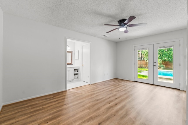 6 Fairmeade Bend Dr, The Woodlands, TX 77381 - unfurnished room featuring light wood-type flooring, a textured ceiling, french doors, and a ceiling fan