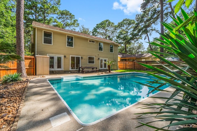 6 Fairmeade Bend Dr, The Woodlands, TX 77381 - view of pool with french doors, a patio area, a fenced backyard, and entry steps