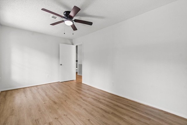 6 Fairmeade Bend Dr, The Woodlands, TX 77381 - unfurnished room with light wood-type flooring, a ceiling fan, and a textured ceiling