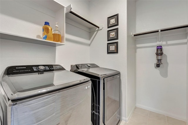 2507 Bay Breeze Dr, Kemah, TX 77565 - laundry area with washer and clothes dryer and light tile patterned floors