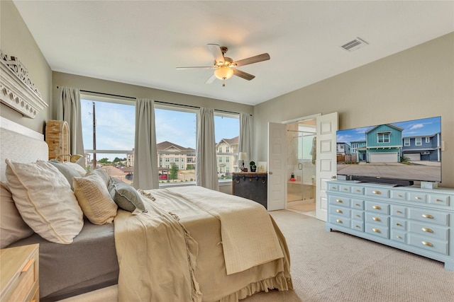 2507 Bay Breeze Dr, Kemah, TX 77565 - bedroom with light colored carpet, connected bathroom, and a ceiling fan