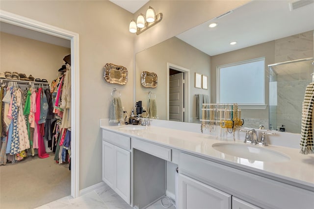 2507 Bay Breeze Dr, Kemah, TX 77565 - bathroom featuring double vanity, a shower stall, a walk in closet, marble look tiles, and recessed lighting