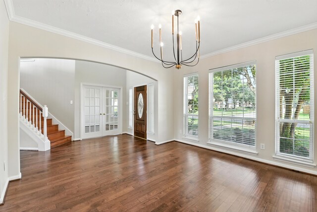 6538 Ivy Heath Ln, Houston, TX 77041 - entrance foyer featuring a chandelier, wood finished floors, stairs, arched walkways, and crown molding