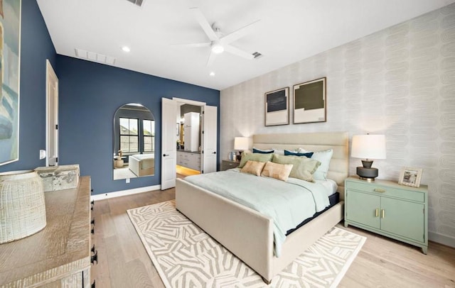 8707 Padua Ln, Houston, TX 77055 - bedroom featuring wallpapered walls, light wood-style flooring, arched walkways, recessed lighting, and ceiling fan