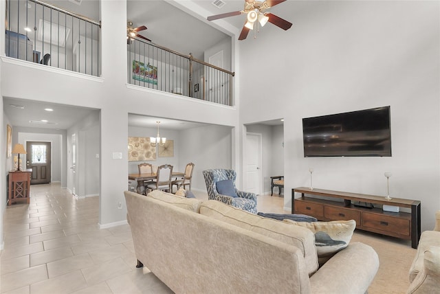 18519 Orono Ridge Trl, Richmond, TX 77407 - tiled living room with a ceiling fan, a high ceiling, and a chandelier