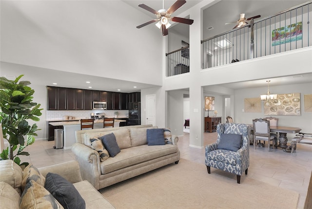 18519 Orono Ridge Trl, Richmond, TX 77407 - living room featuring ceiling fan, light tile patterned floors, a chandelier, and a towering ceiling