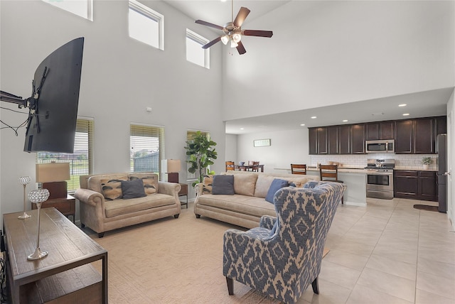 18519 Orono Ridge Trl, Richmond, TX 77407 - living area with ceiling fan, a towering ceiling, light tile patterned floors, and healthy amount of natural light