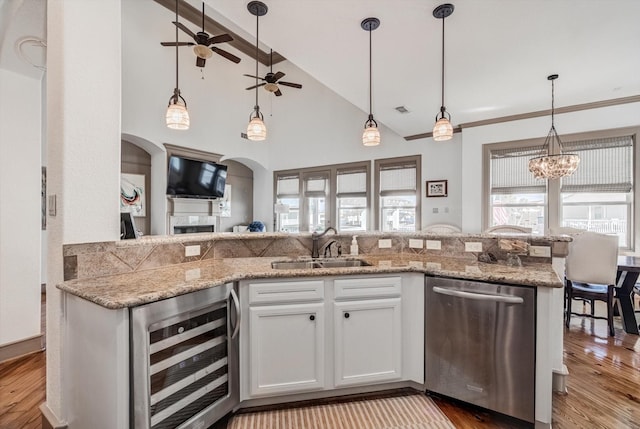 4216 Karankawa Way, Jamaica Beach, TX 77554 - kitchen featuring beverage cooler, dishwasher, a ceiling fan, wood finished floors, and white cabinetry