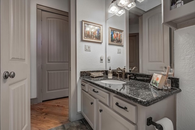 4216 Karankawa Way, Jamaica Beach, TX 77554 - bathroom featuring vanity, a textured wall, and wood finished floors