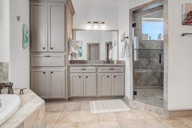 4216 Karankawa Way, Jamaica Beach, TX 77554 - full bathroom featuring vanity, a stall shower, a garden tub, and tile patterned flooring