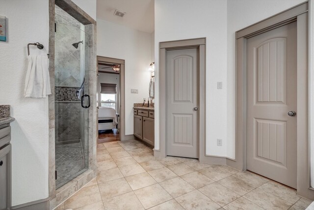 4216 Karankawa Way, Jamaica Beach, TX 77554 - bathroom featuring vanity, a shower stall, tile patterned flooring, and a ceiling fan