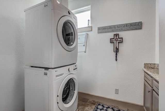 4216 Karankawa Way, Jamaica Beach, TX 77554 - laundry area with stacked washer and clothes dryer and cabinet space