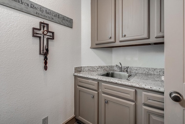 4216 Karankawa Way, Jamaica Beach, TX 77554 - kitchen featuring gray cabinetry and a textured wall