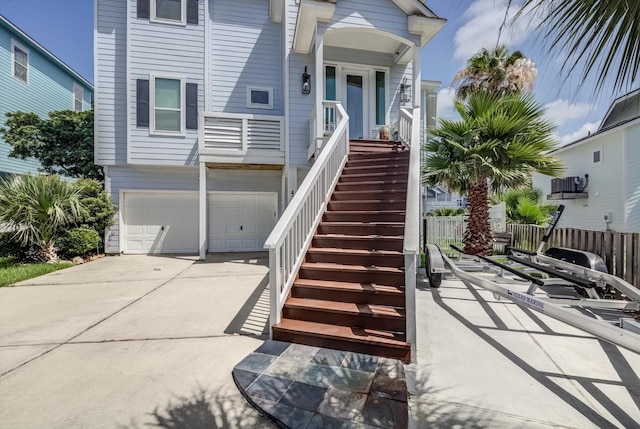 4216 Karankawa Way, Jamaica Beach, TX 77554 - view of front of house with stairway, concrete driveway, a garage, and a porch