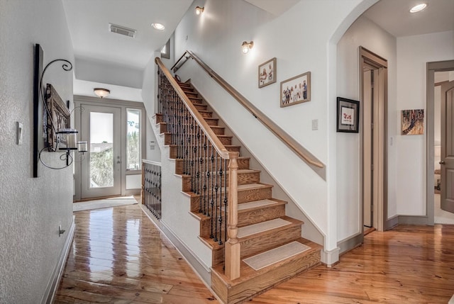 4216 Karankawa Way, Jamaica Beach, TX 77554 - foyer entrance featuring light wood-style flooring, stairway, arched walkways, and recessed lighting