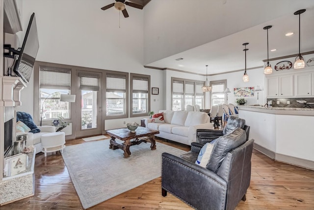 4216 Karankawa Way, Jamaica Beach, TX 77554 - living area featuring a ceiling fan, light wood-style floors, a towering ceiling, crown molding, and recessed lighting