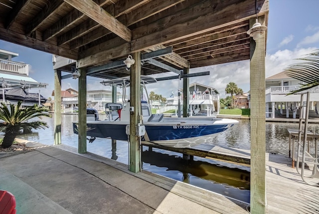 4216 Karankawa Way, Jamaica Beach, TX 77554 - dock with boat lift, a water view, and a residential view