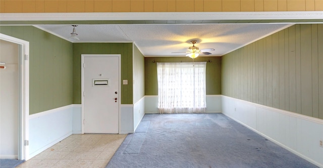 826 Kentucky St, Deer Park, TX 77536 - carpeted empty room with crown molding, a ceiling fan, and wood walls