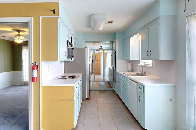 826 Kentucky St, Deer Park, TX 77536 - kitchen with ceiling fan, white appliances, light countertops, plenty of natural light, and a textured ceiling