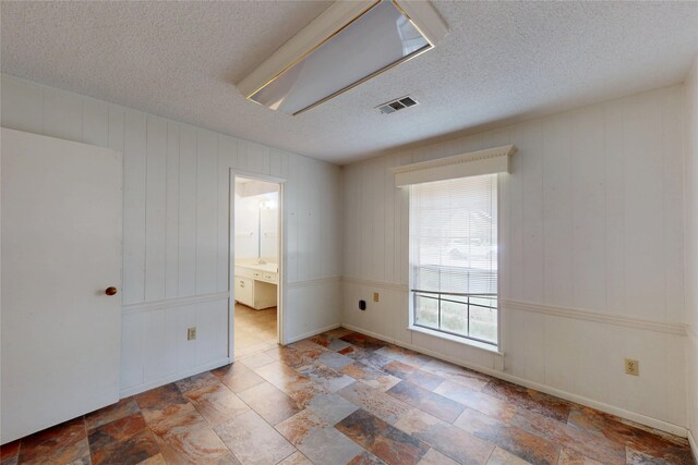 826 Kentucky St, Deer Park, TX 77536 - spare room with a textured ceiling and stone finish floors