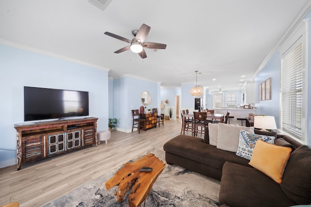 4121 Pointe W Dr Unit 301, Galveston, TX 77554 - living area with ceiling fan, light wood finished floors, and ornamental molding