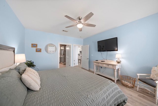 4121 Pointe W Dr Unit 301, Galveston, TX 77554 - bedroom with light wood-style floors, a ceiling fan, and ensuite bathroom