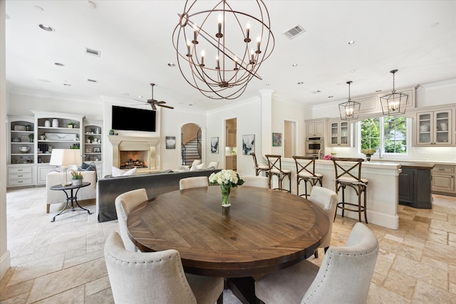 2 Hedwig Shadows Dr, Houston, TX 77024 - dining room featuring stone tile floors, a ceiling fan, crown molding, a fireplace, and recessed lighting