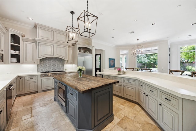 2 Hedwig Shadows Dr, Houston, TX 77024 - kitchen featuring built in appliances, open shelves, a chandelier, a kitchen island, and wooden counters
