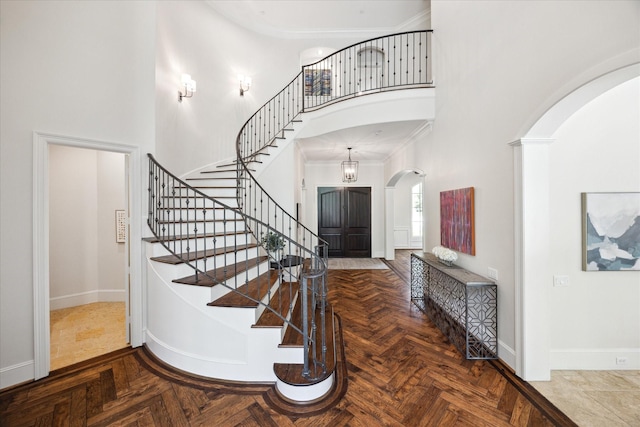 2 Hedwig Shadows Dr, Houston, TX 77024 - stairs featuring arched walkways, a towering ceiling, and crown molding