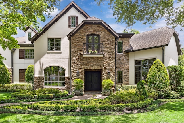2 Hedwig Shadows Dr, Houston, TX 77024 - tudor house featuring a balcony, stone siding, and stucco siding
