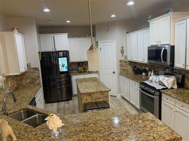 8927 Alcina Dr, Tomball, TX 77375 - kitchen featuring stainless steel appliances, tasteful backsplash, light wood finished floors, white cabinetry, and recessed lighting
