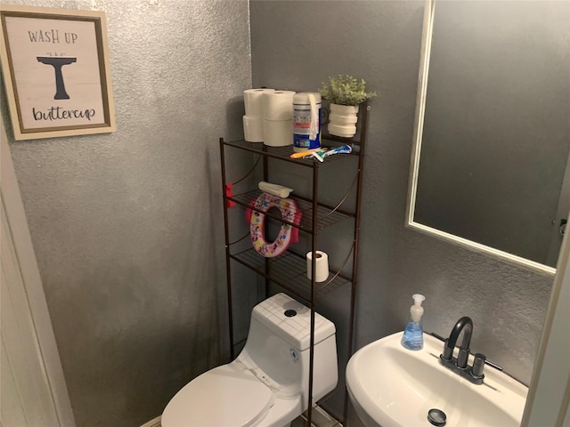 8927 Alcina Dr, Tomball, TX 77375 - half bath featuring a textured wall and a sink