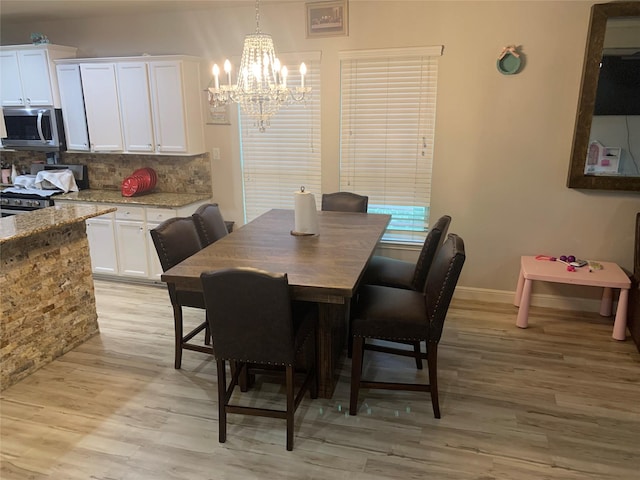8927 Alcina Dr, Tomball, TX 77375 - dining room with a chandelier and light wood-type flooring