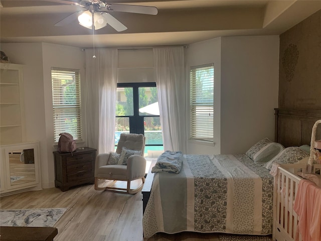 8927 Alcina Dr, Tomball, TX 77375 - bedroom with light wood finished floors and ceiling fan