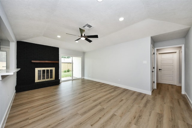 10415 Towne Oak Ln, Sugar Land, TX 77498 - unfurnished living room featuring lofted ceiling, light wood finished floors, a ceiling fan, recessed lighting, and a textured ceiling