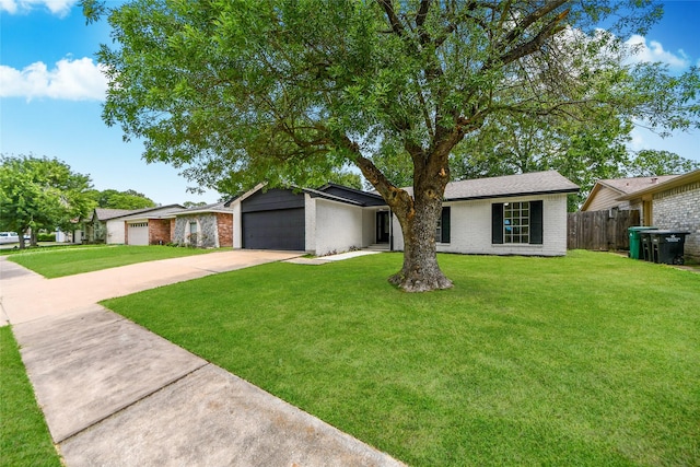 10415 Towne Oak Ln, Sugar Land, TX 77498 - view of front of home featuring brick siding, a garage, and concrete driveway