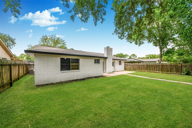 10415 Towne Oak Ln, Sugar Land, TX 77498 - back of property featuring a chimney, a fenced backyard, a patio, and brick siding