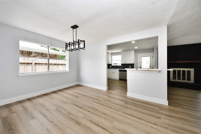 10415 Towne Oak Ln, Sugar Land, TX 77498 - unfurnished dining area featuring a chandelier, light wood-style flooring, and recessed lighting