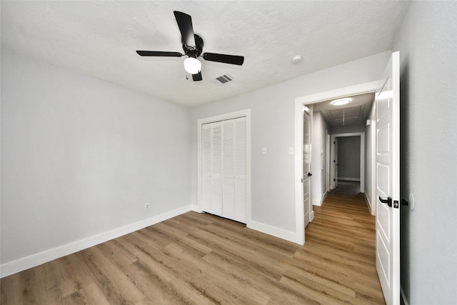 10415 Towne Oak Ln, Sugar Land, TX 77498 - unfurnished bedroom featuring attic access, light wood-style flooring, a closet, and a ceiling fan
