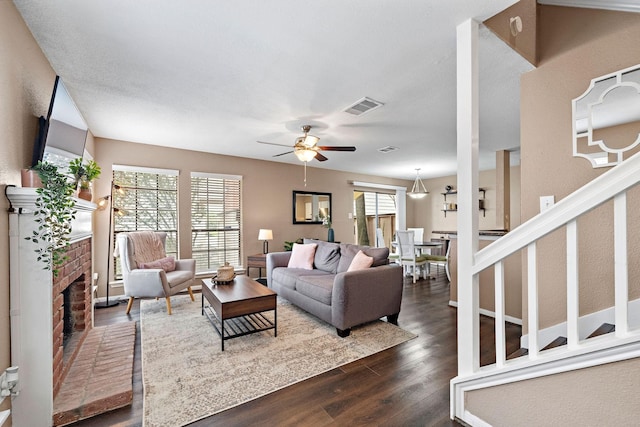 2211 S Kirkwood Rd Unit 23, Houston, TX 77077 - living room with ceiling fan, dark wood-style flooring, and a brick fireplace