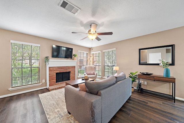2211 S Kirkwood Rd Unit 23, Houston, TX 77077 - living area featuring a fireplace, dark wood finished floors, a ceiling fan, and a textured ceiling