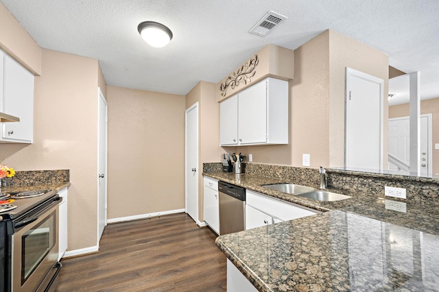 2211 S Kirkwood Rd Unit 23, Houston, TX 77077 - kitchen with appliances with stainless steel finishes, dark wood finished floors, dark stone counters, white cabinetry, and a textured ceiling