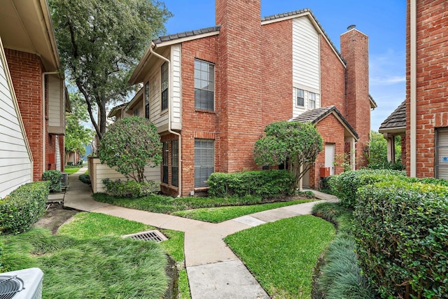 2211 S Kirkwood Rd Unit 23, Houston, TX 77077 - view of side of home featuring brick siding and a chimney